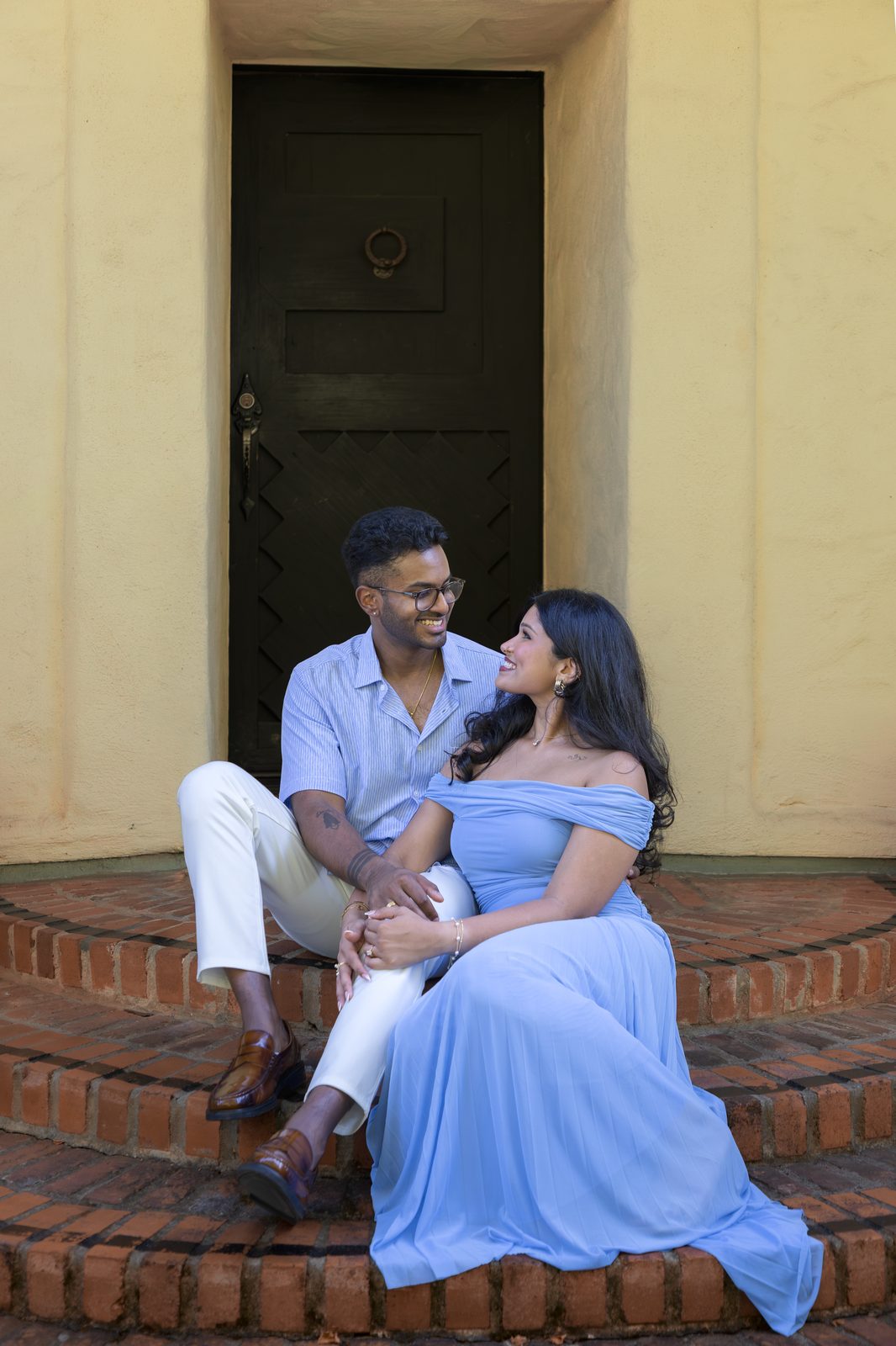 Seated on steps, yellow wall — Allied Arts Guild