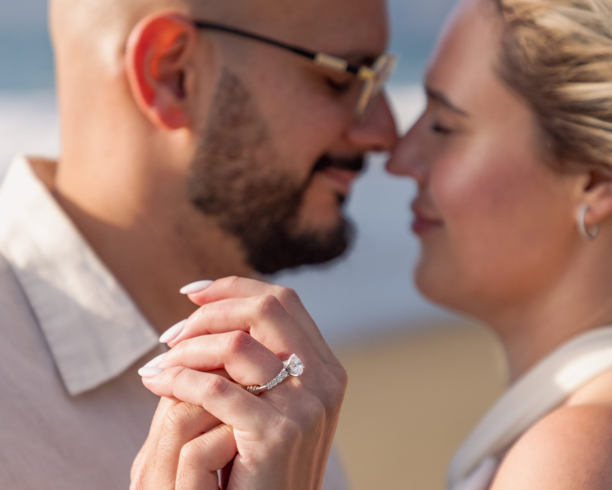Ring in focus, noses almost touching behind it